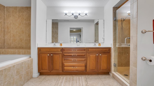 264 Gibraltar Ct Unit 101, Saint Augustine, FL 32080 - bathroom featuring tile patterned flooring, a shower stall, double vanity, and tiled tub