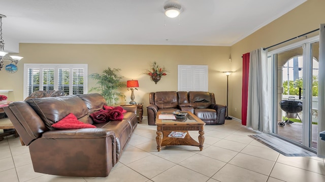 264 Gibraltar Ct Unit 101, Saint Augustine, FL 32080 - living room featuring light tile patterned floors, crown molding, a chandelier, and baseboards