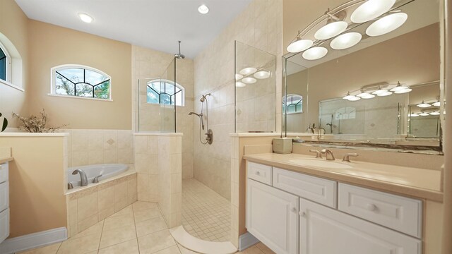 bathroom featuring tile patterned floors, vanity, and independent shower and bath