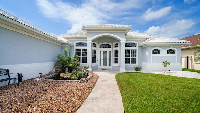 entrance to property featuring a lawn