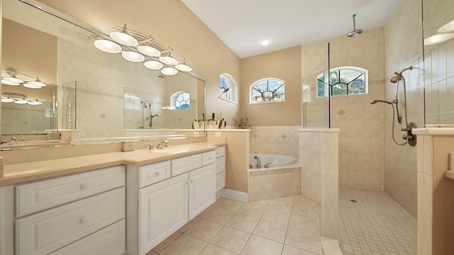 bathroom with tile patterned flooring, vanity, and plus walk in shower