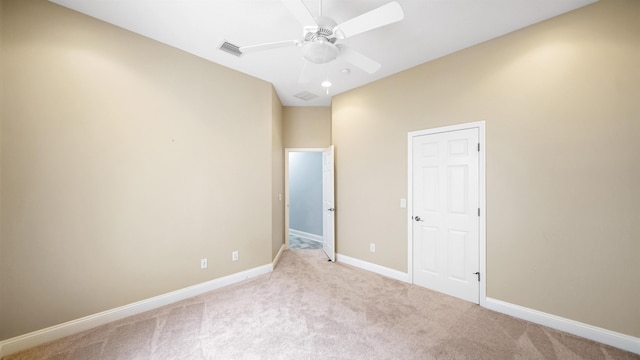 unfurnished bedroom featuring ceiling fan and light colored carpet