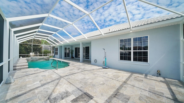 view of pool featuring glass enclosure and a patio