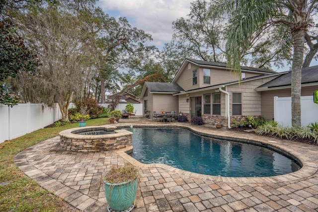 view of pool with an in ground hot tub and a patio