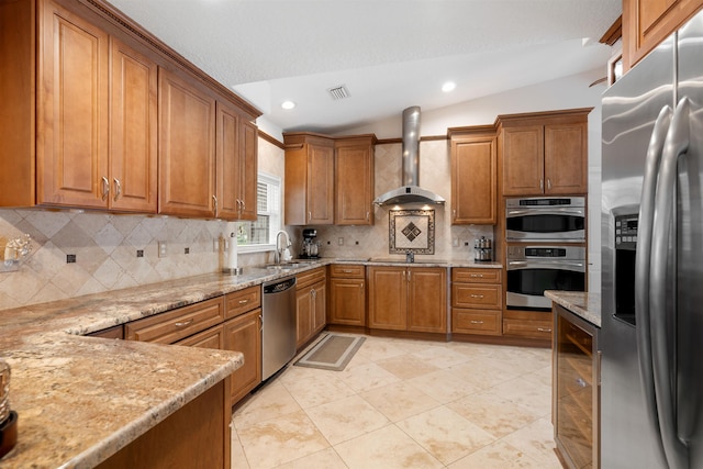 kitchen with appliances with stainless steel finishes, sink, wine cooler, light stone counters, and wall chimney range hood