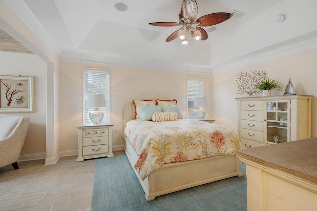 bedroom featuring ceiling fan, ornamental molding, and a raised ceiling