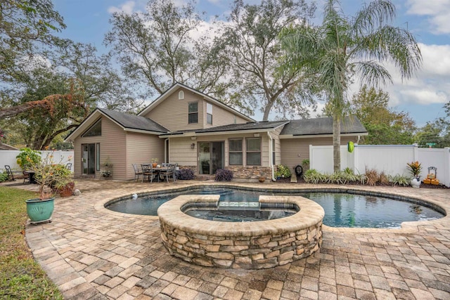 view of swimming pool featuring an in ground hot tub and a patio area