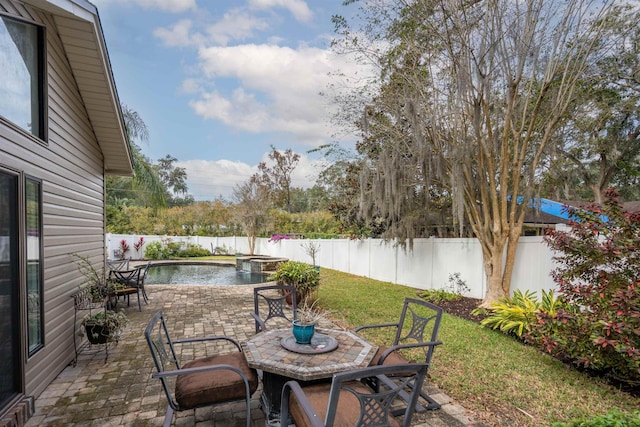 view of patio with a fenced in pool and a water view