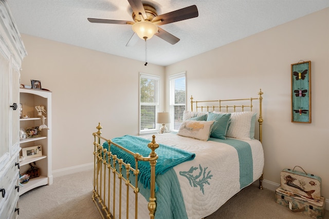 bedroom featuring ceiling fan, carpet flooring, and a textured ceiling