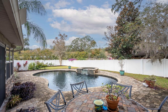 view of swimming pool with a patio and an in ground hot tub