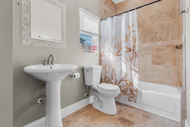 bathroom featuring shower / bath combo and toilet