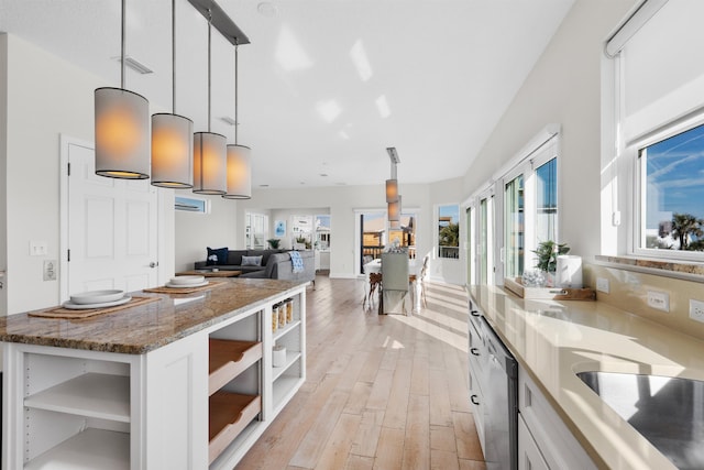 kitchen with pendant lighting, stone countertops, light hardwood / wood-style flooring, and white cabinets