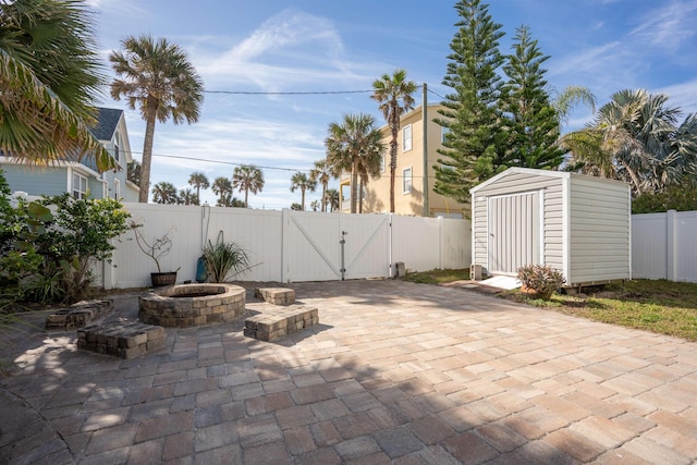 view of patio / terrace featuring a storage shed and a fire pit