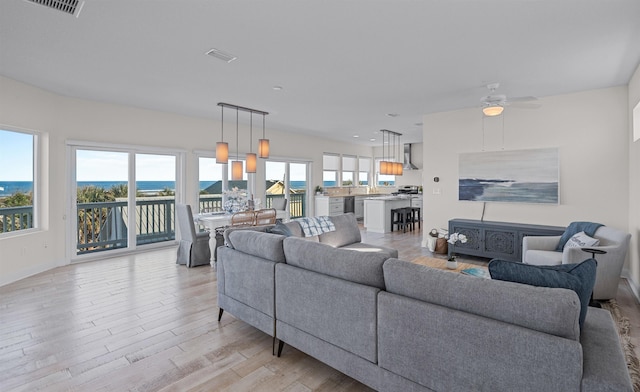 living room featuring light hardwood / wood-style flooring and ceiling fan