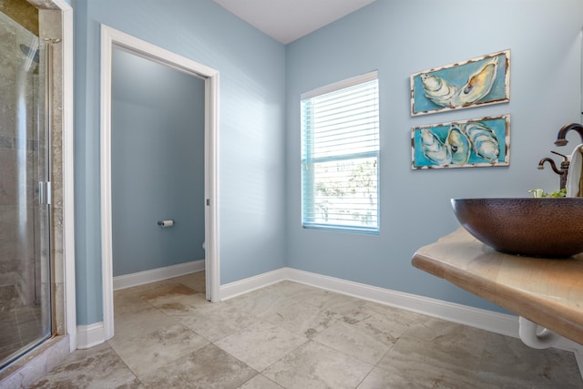 bathroom featuring an enclosed shower and sink