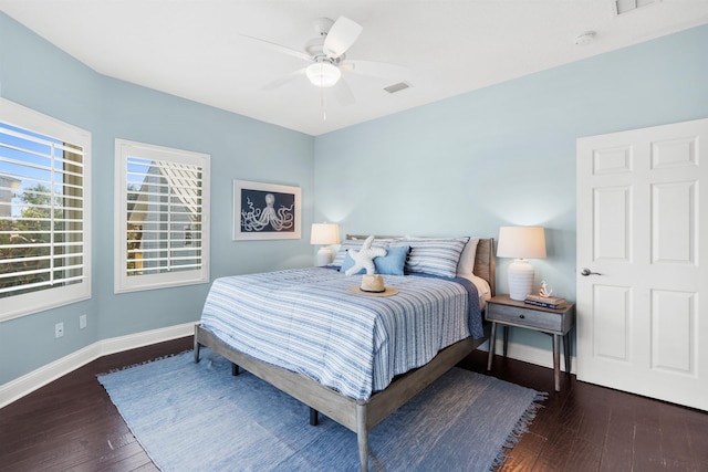 bedroom with dark hardwood / wood-style flooring and ceiling fan