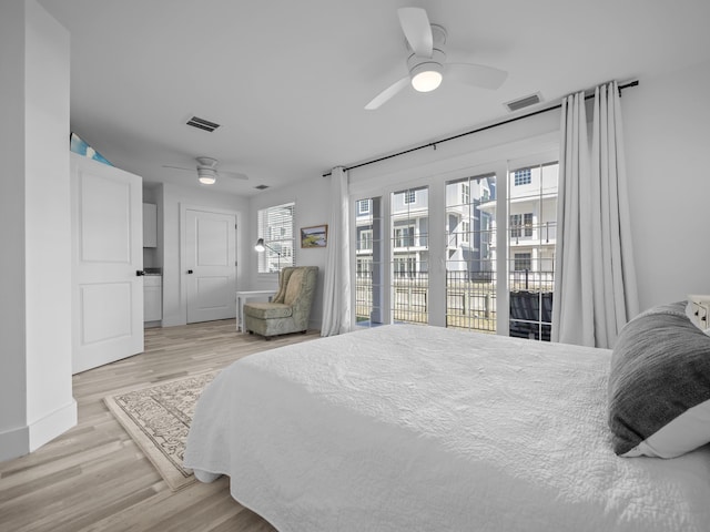 bedroom featuring access to exterior, ceiling fan, and light wood-type flooring