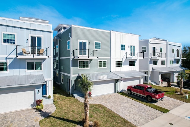 view of property featuring a front yard and a garage