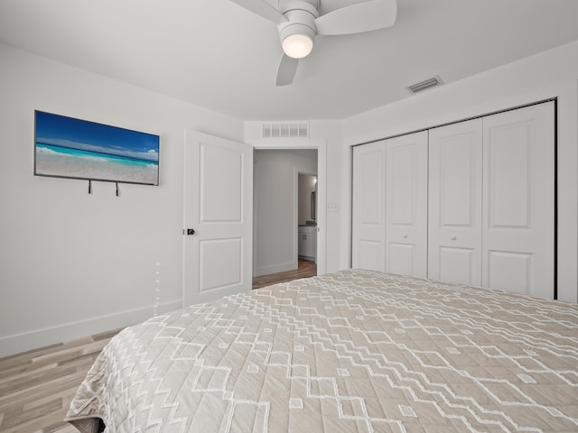 bedroom with a closet, ceiling fan, and hardwood / wood-style flooring