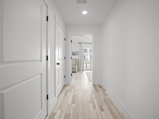 corridor with light hardwood / wood-style flooring