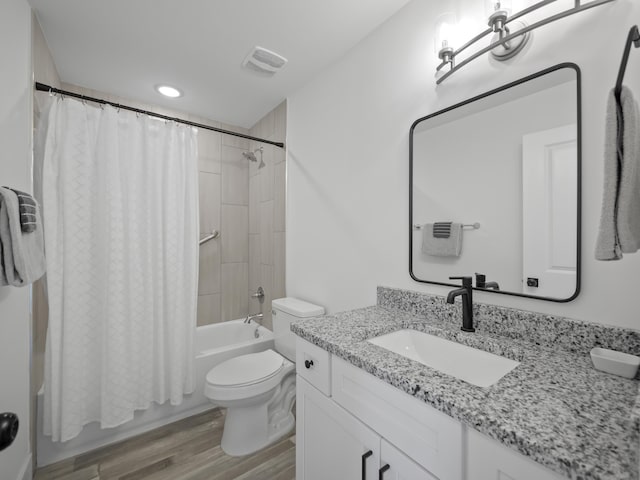 full bathroom featuring toilet, shower / bathtub combination with curtain, vanity, and hardwood / wood-style floors