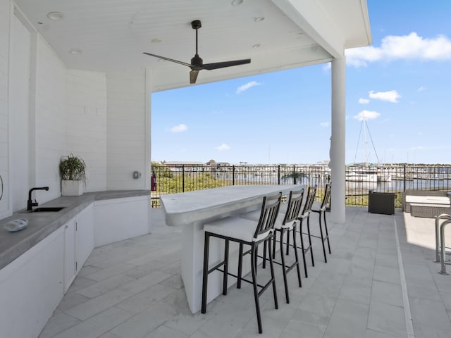 view of patio featuring ceiling fan and an outdoor wet bar