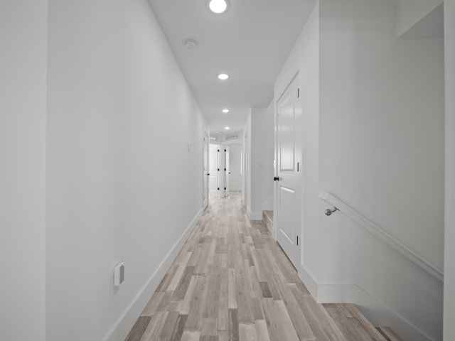 hallway with light hardwood / wood-style flooring