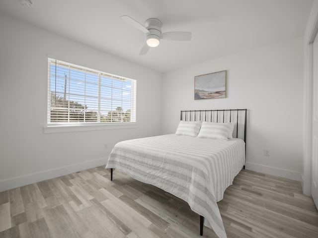 bedroom with ceiling fan and light hardwood / wood-style flooring