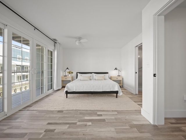 bedroom featuring access to exterior, ceiling fan, and light wood-type flooring