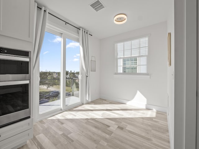 unfurnished room with light hardwood / wood-style floors