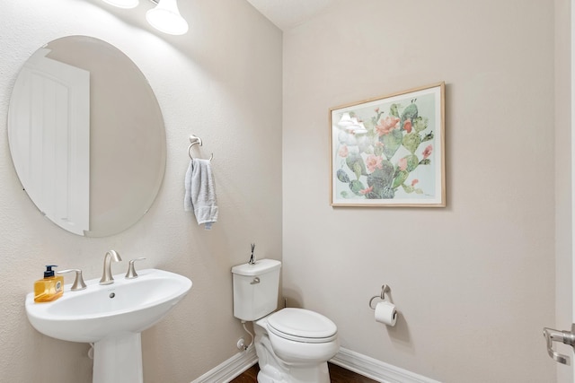 bathroom featuring toilet and sink