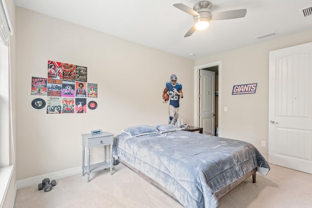 bedroom featuring ceiling fan and light carpet