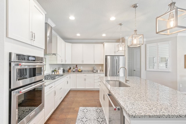 kitchen featuring a kitchen island with sink, appliances with stainless steel finishes, sink, and white cabinetry