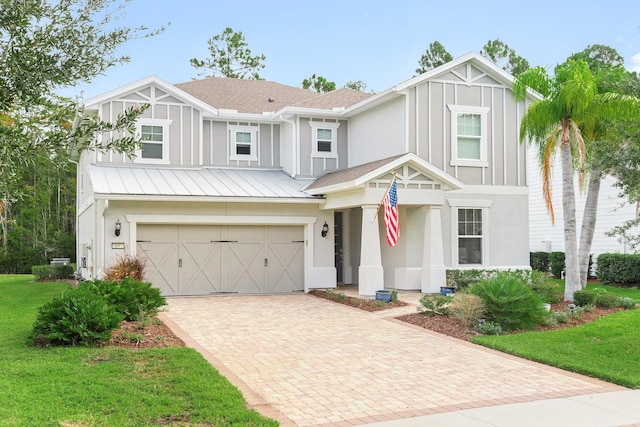 view of front facade with a garage and a front lawn