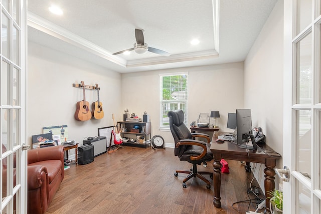 office featuring hardwood / wood-style flooring, ceiling fan, a raised ceiling, french doors, and ornamental molding