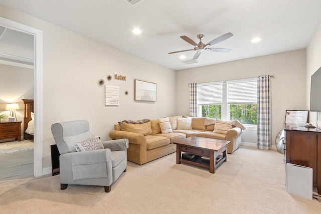 living room with light carpet and ceiling fan