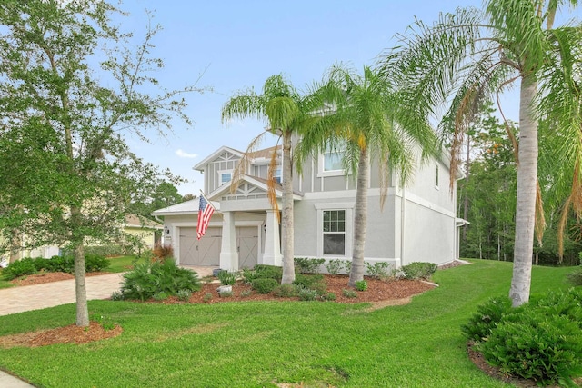 view of front of property with a garage and a front lawn