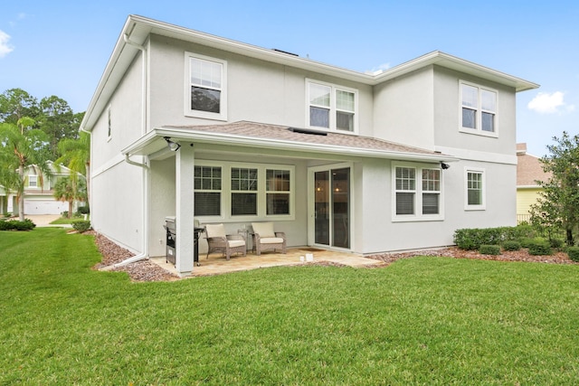 back of house with a patio area and a yard