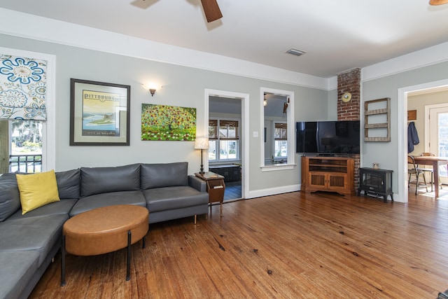 living room featuring hardwood / wood-style floors and ceiling fan