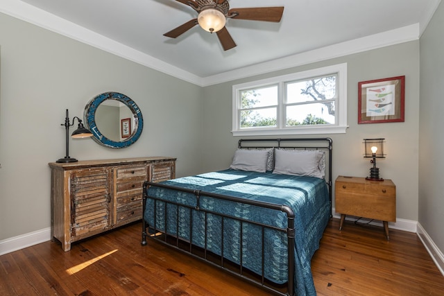 bedroom featuring crown molding, dark hardwood / wood-style floors, and ceiling fan