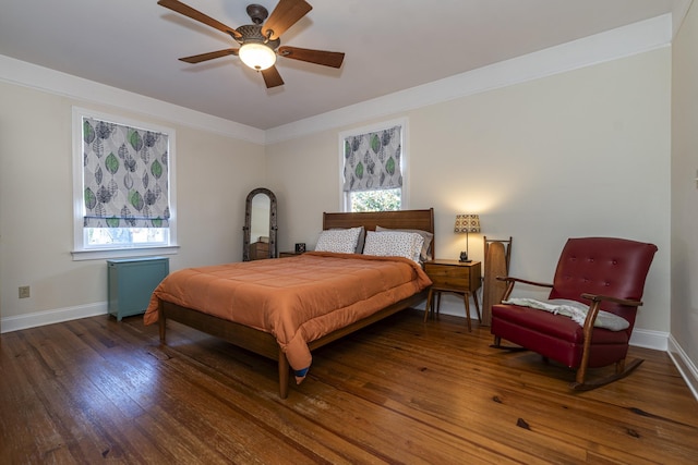 bedroom with multiple windows, dark wood-type flooring, ornamental molding, and ceiling fan