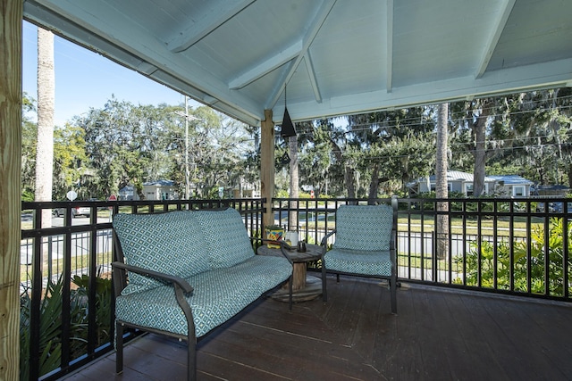 sunroom / solarium with vaulted ceiling with beams