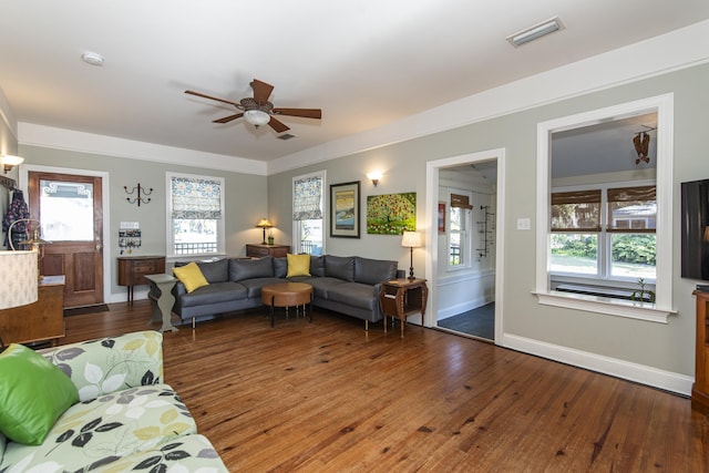 living room featuring ceiling fan, a healthy amount of sunlight, and dark hardwood / wood-style flooring