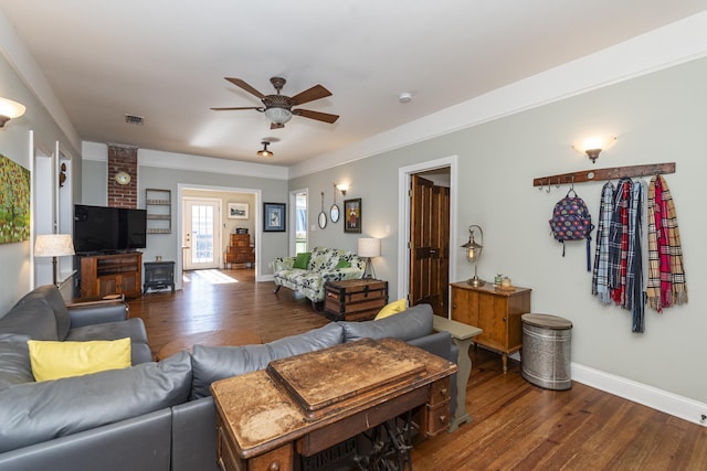 living room featuring ceiling fan and dark hardwood / wood-style floors