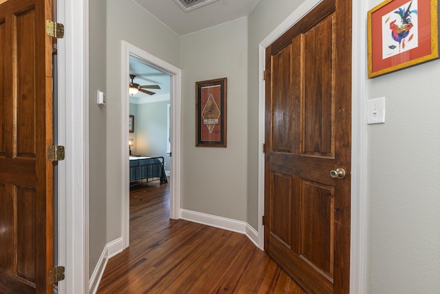 hall featuring crown molding and dark hardwood / wood-style flooring