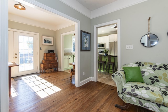 interior space featuring ornamental molding and wood-type flooring