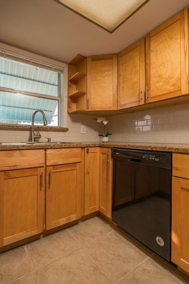 kitchen with dishwasher, sink, stone countertops, and decorative backsplash