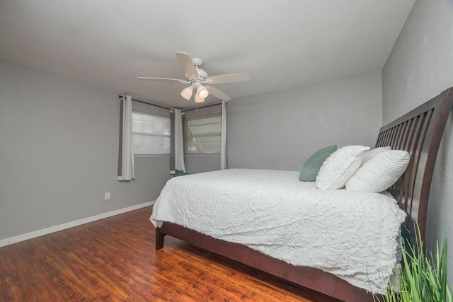 bedroom with dark hardwood / wood-style floors and ceiling fan