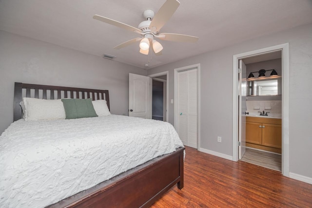 bedroom with sink, ceiling fan, dark hardwood / wood-style floors, ensuite bathroom, and a closet