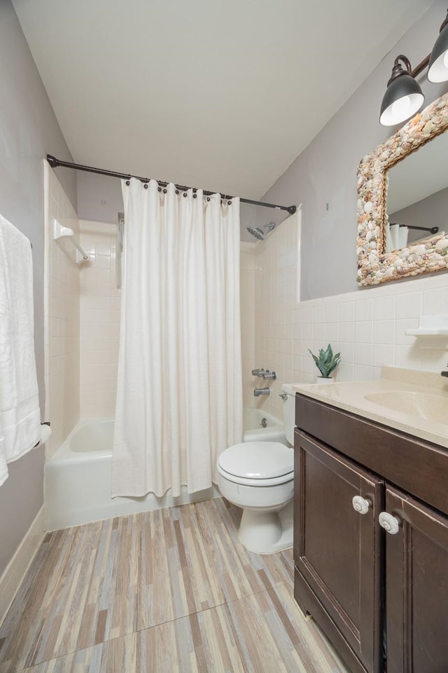 full bathroom with tile walls, vanity, wood-type flooring, and shower / bath combination with curtain